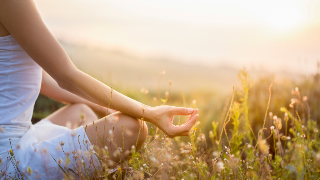 mindfulness practice with person meditating in nature.