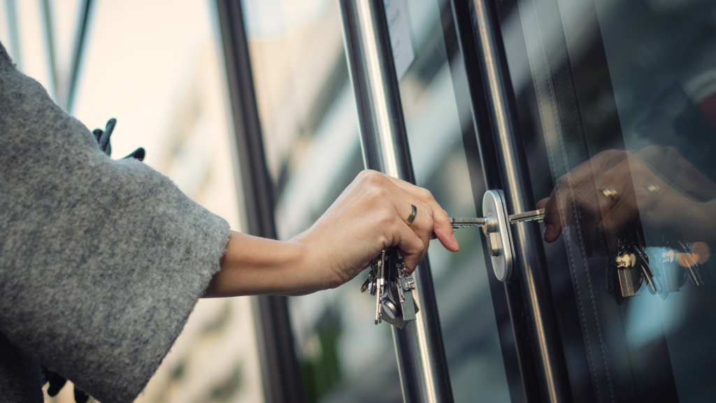 A person unlocking a door symbolizing potential.